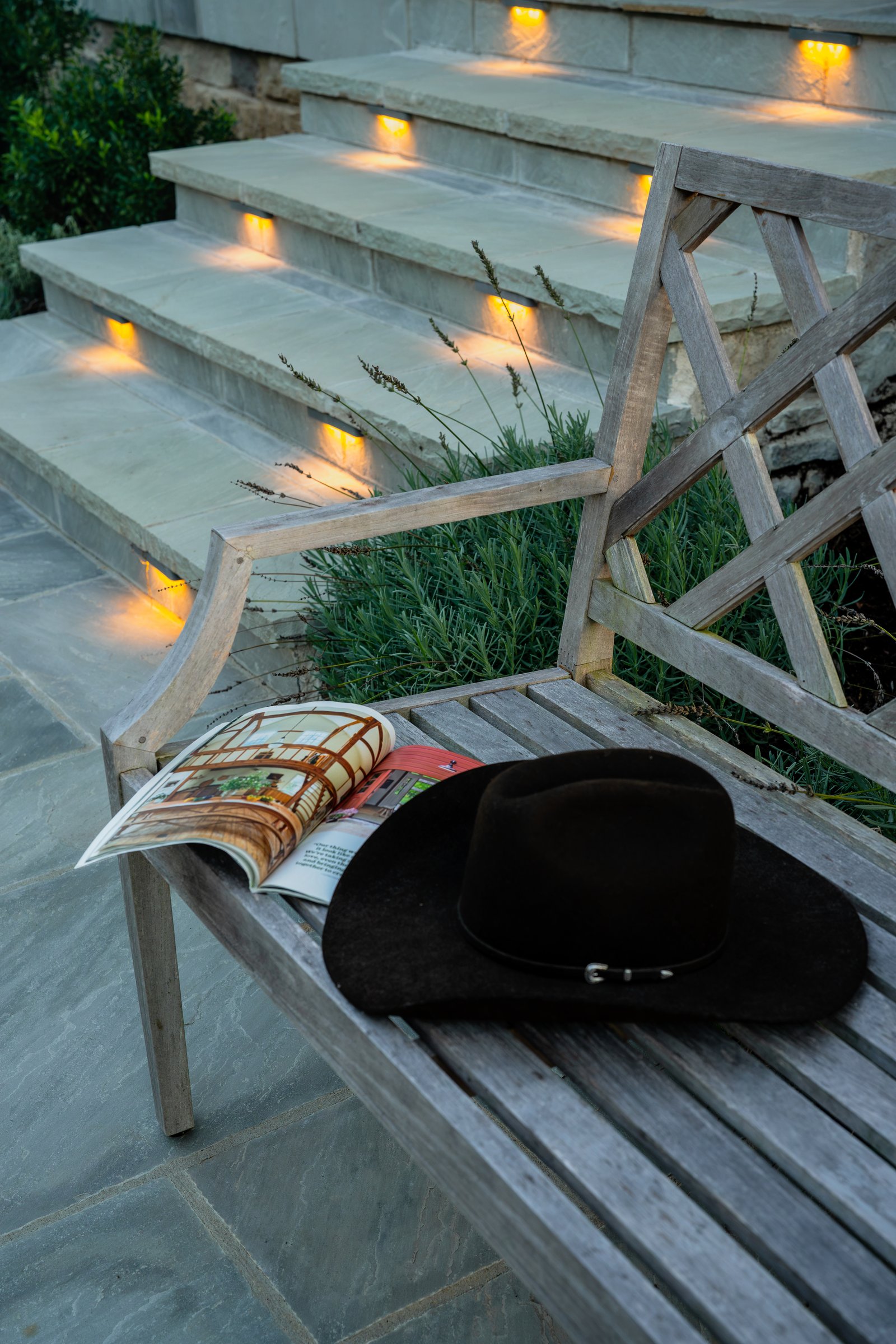 Stone landing with lavender, path lighting and a bench