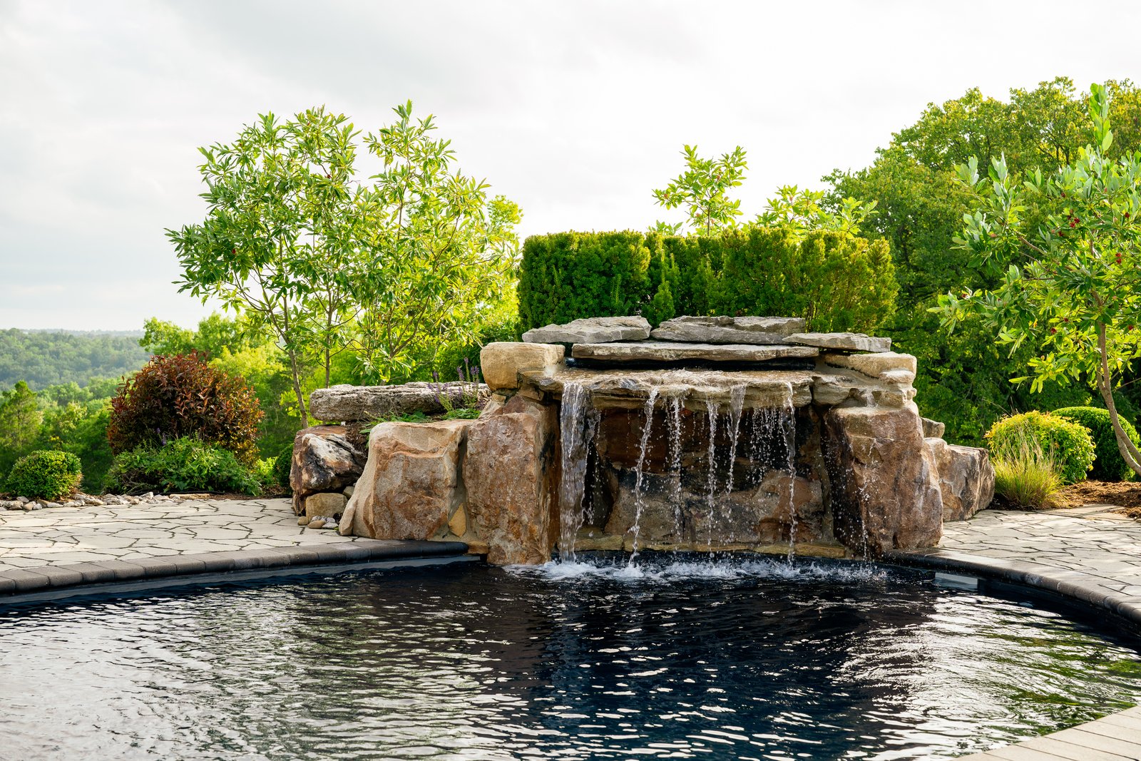 Rock waterfall spilling into a pool